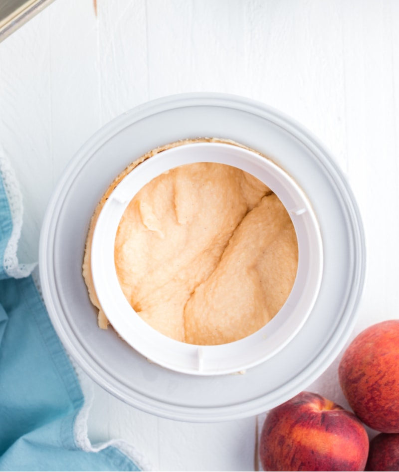 fresh peach ice cream churning in ice cream maker