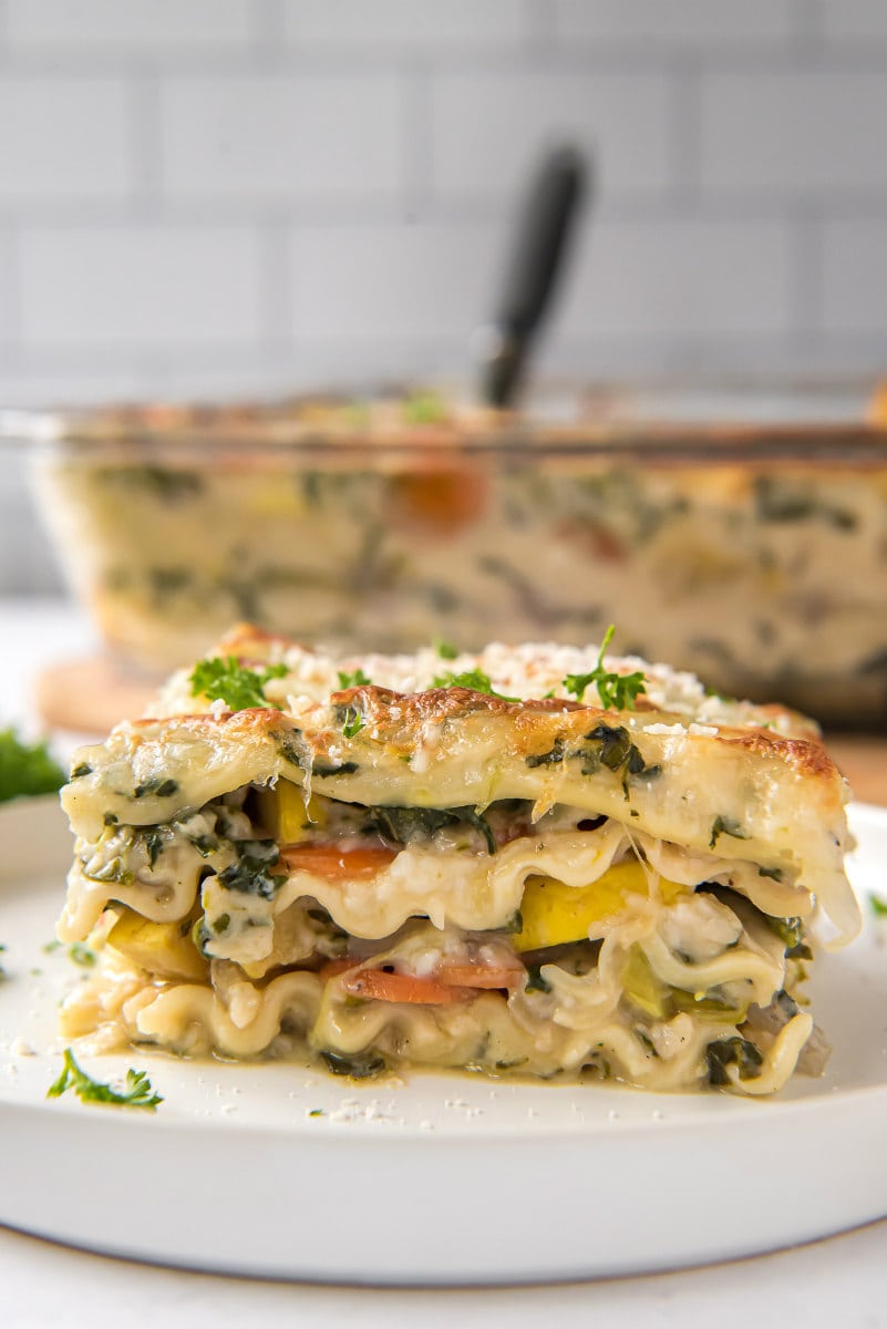 Garden Vegetable Lasagna recipe from RecipeGirl.com #garden #vegetable #vegetables #pasta #lasagna #vegetarian #recipe #RecipeGirl slice of garden vegetable lasagna on a white plate