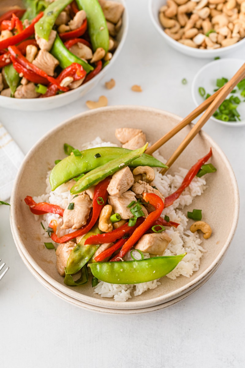 garlic chicken stir fry in a bowl with chopsticks