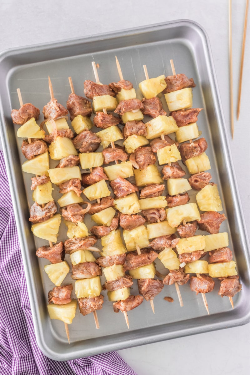 pork and pineapple kebabs on baking sheet