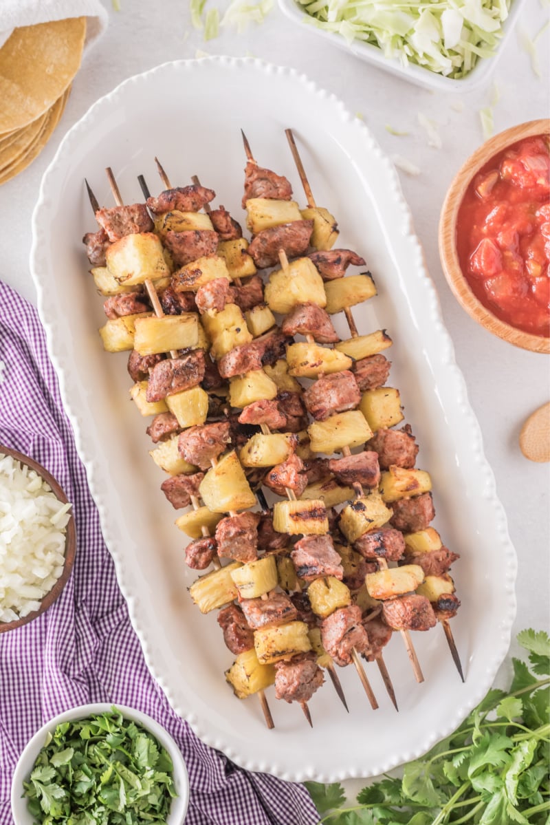 pork and pineapple kebabs on a white plate