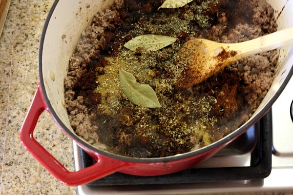 Halftime Chili recipe from RecipeGirl.com #halftime #chili #superbowl #recipe #RecipeGirl Making chili in red pot