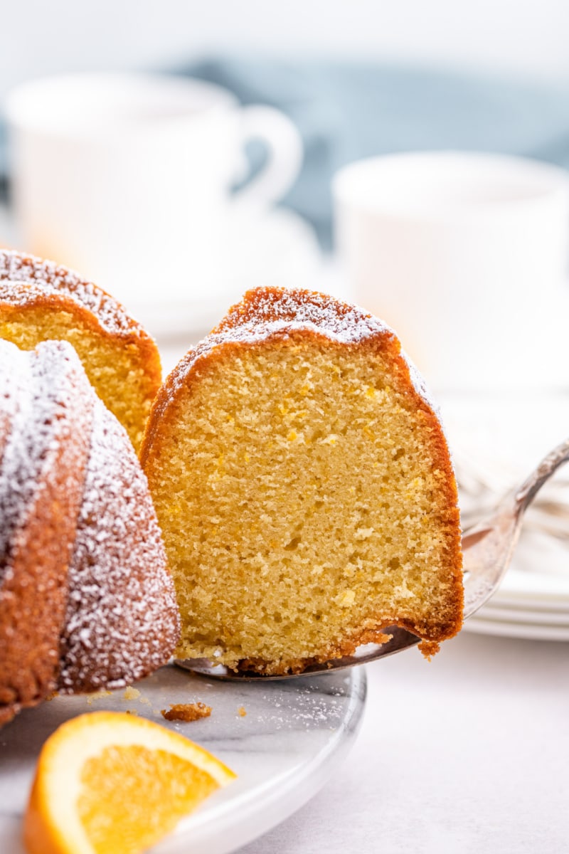 slicing orange cake from bundt