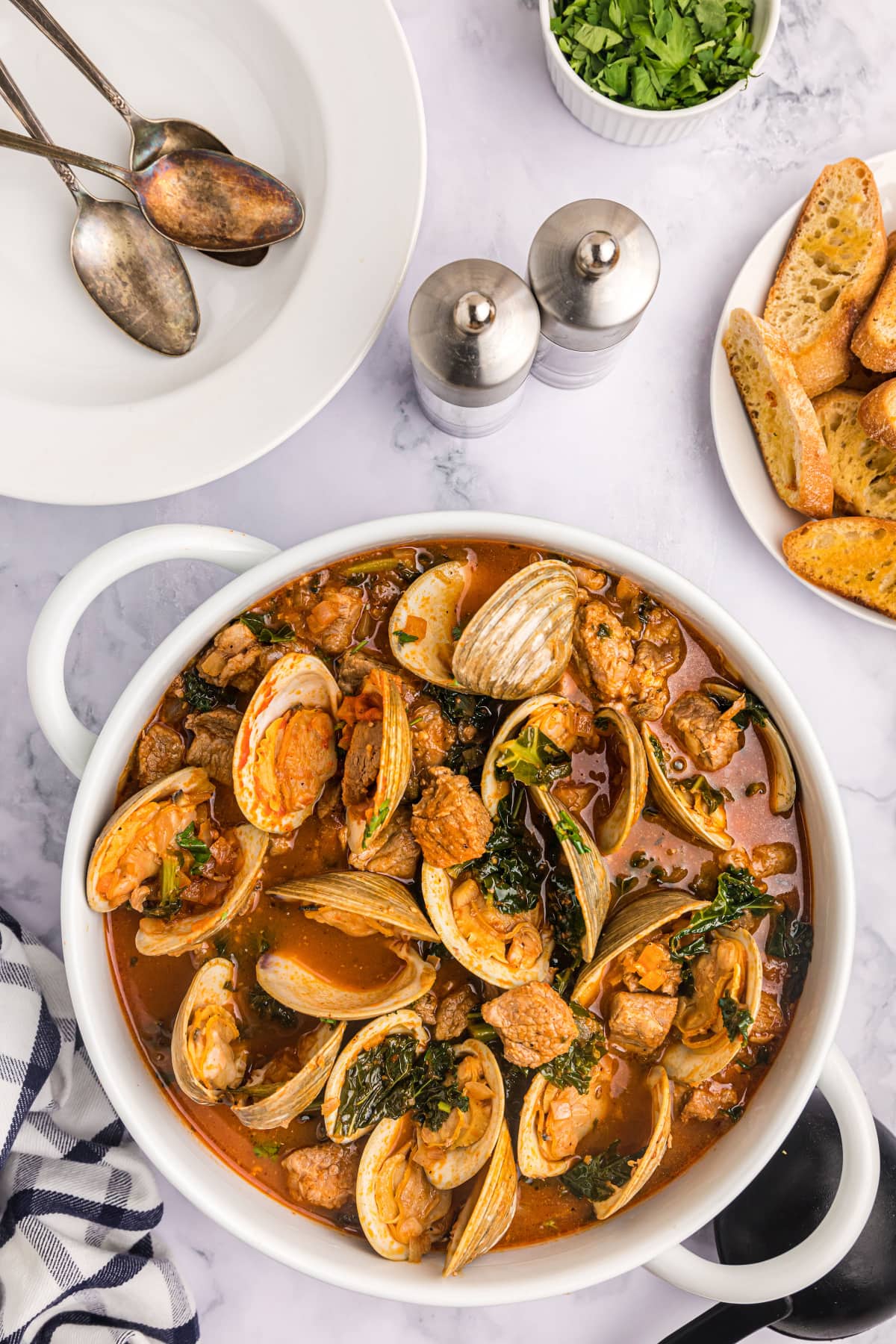 pot of pork stew with clams and mussels