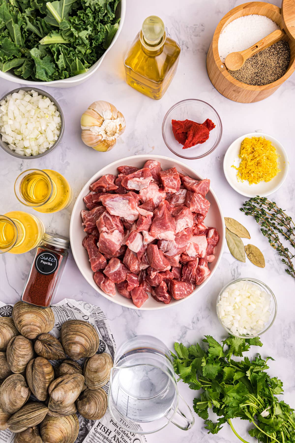 ingredients displayed for making pork stew with clams and mussels