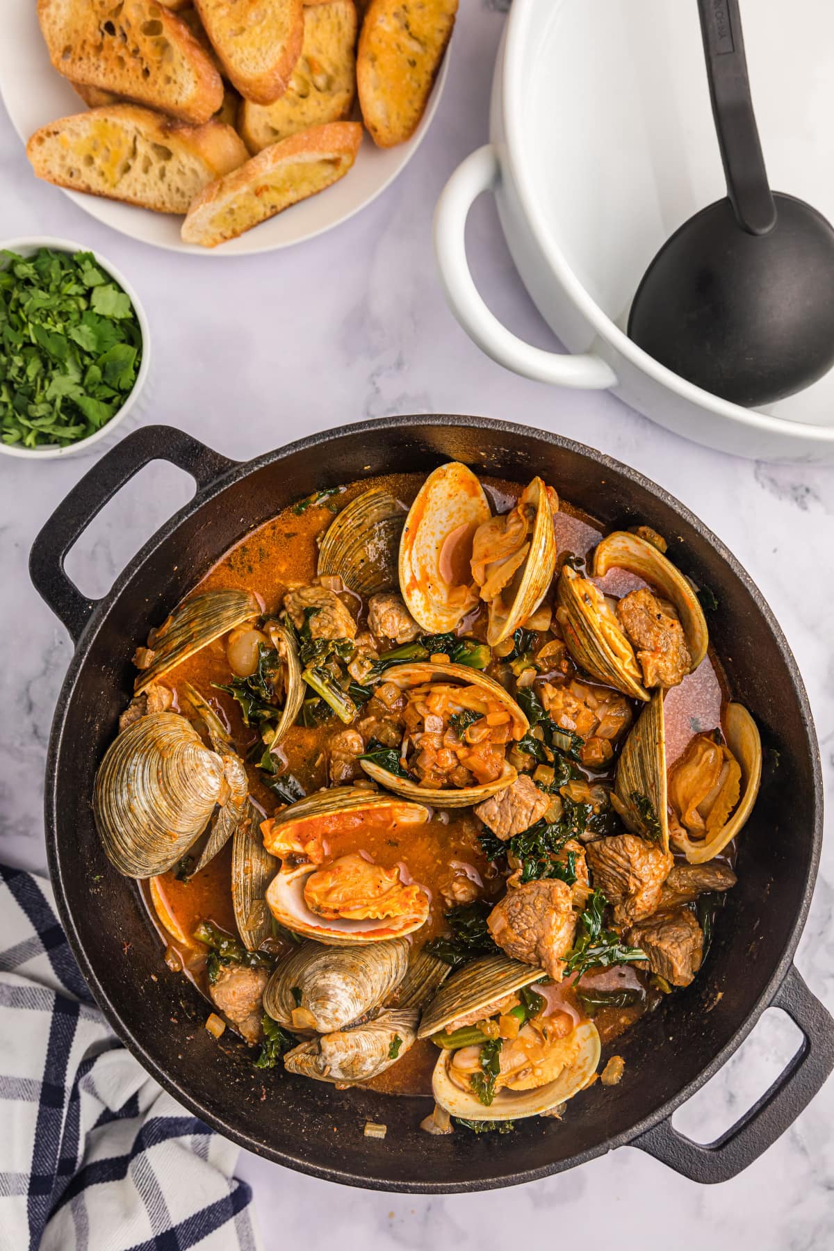 pot of pork stew with clams and mussels