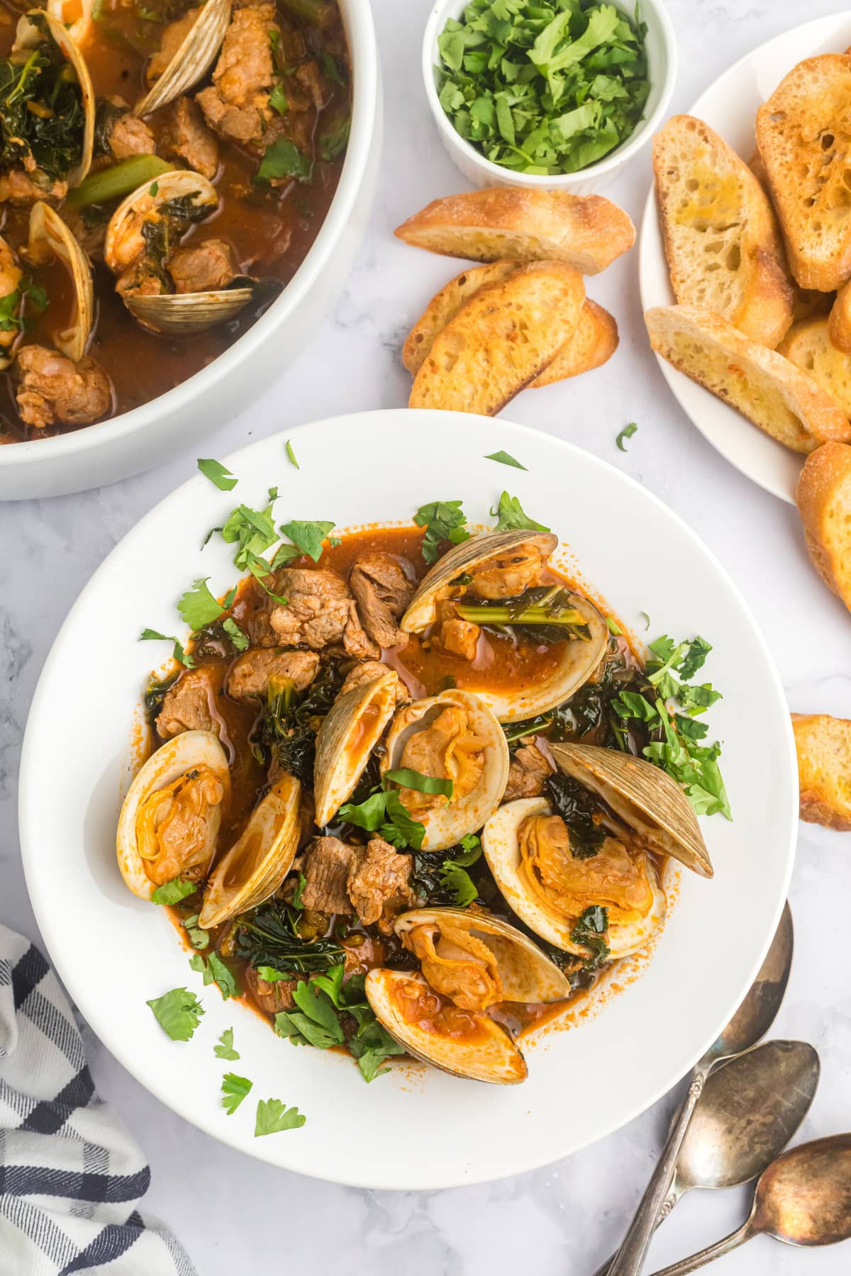 bowl of pork stew with clams and mussels