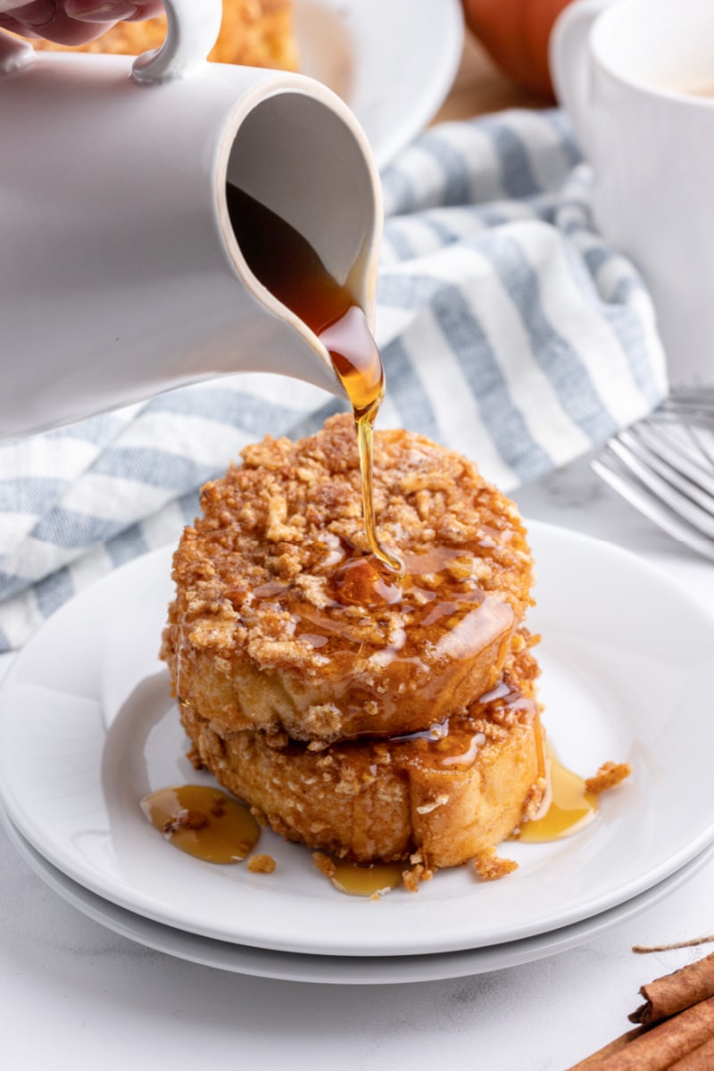 Pouring syrup onto french toast