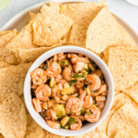 shrimp ceviche in a bowl surrounded by tortilla chips
