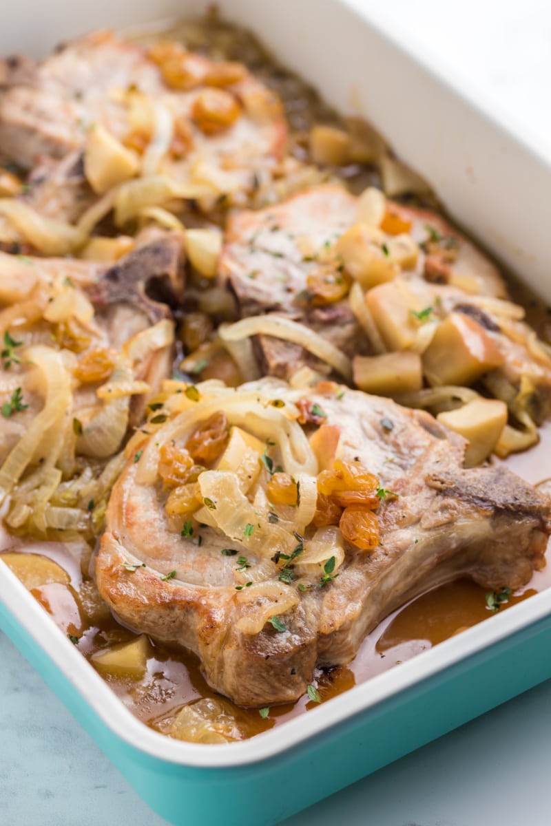 smoked pork chops with maple baked apples in a casserole dish