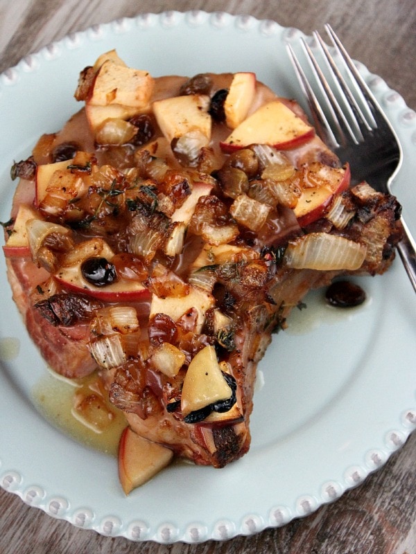 Smoked pork chop with apples on a plate
