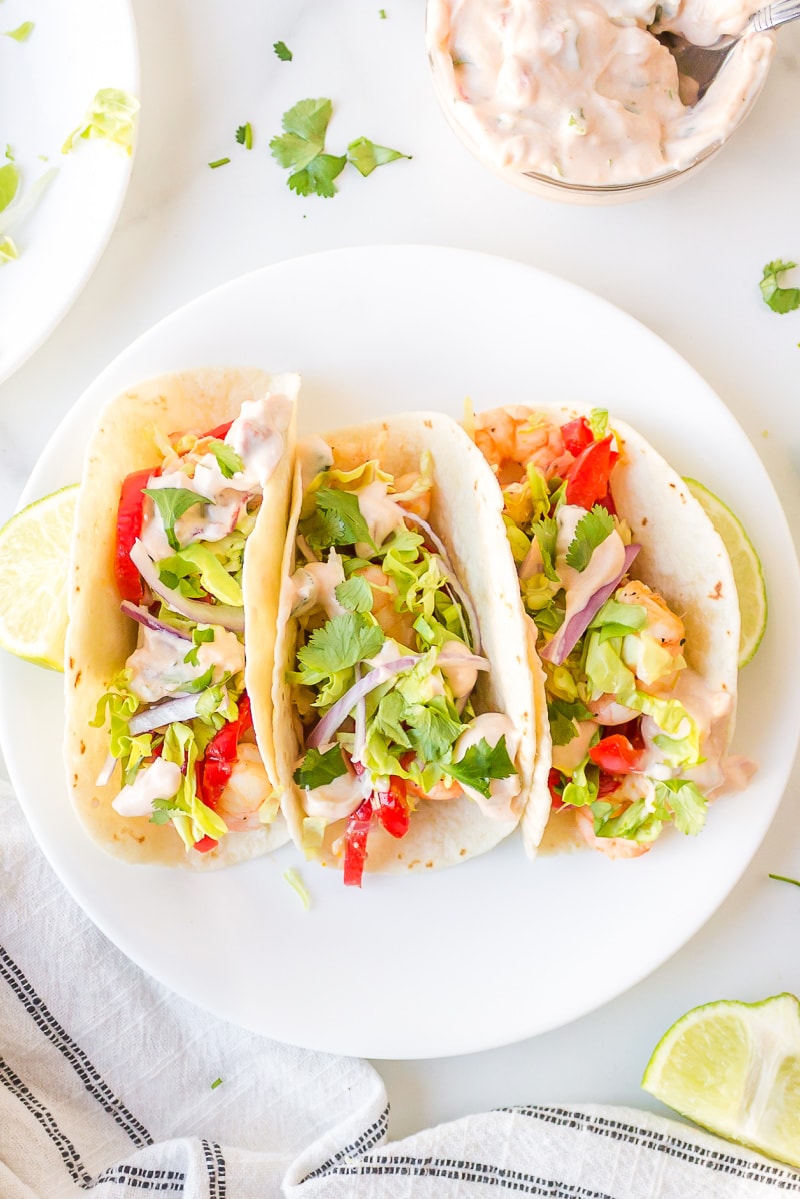 three tacos on a white plate