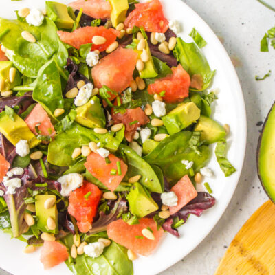 watermelon and avocado salad on a white plate