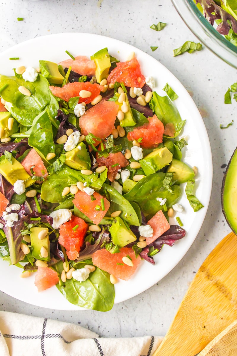 watermelon and avocado salad on a white plate