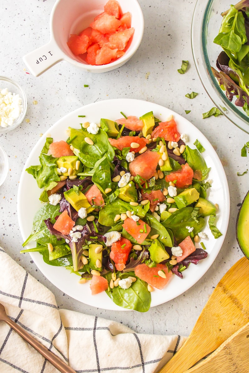 watermelon and avocado salad on a wite plate