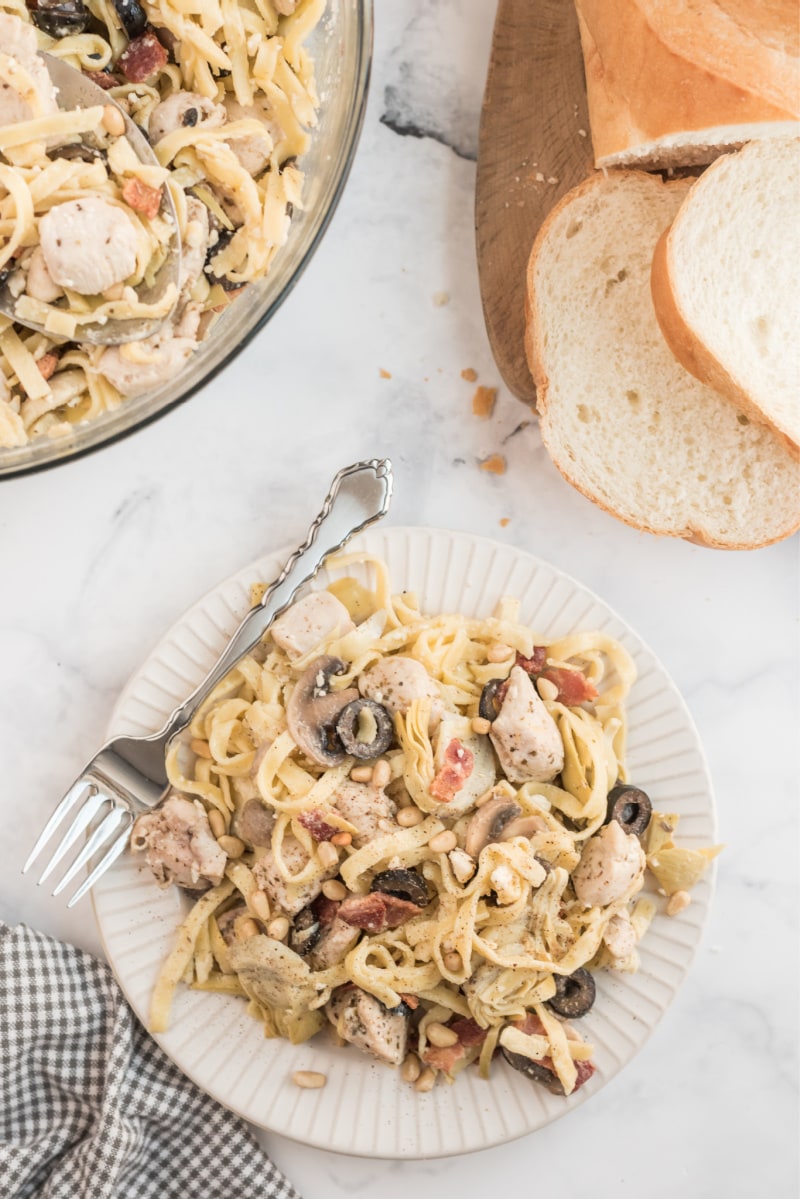 serving of pasta on white plate with fork