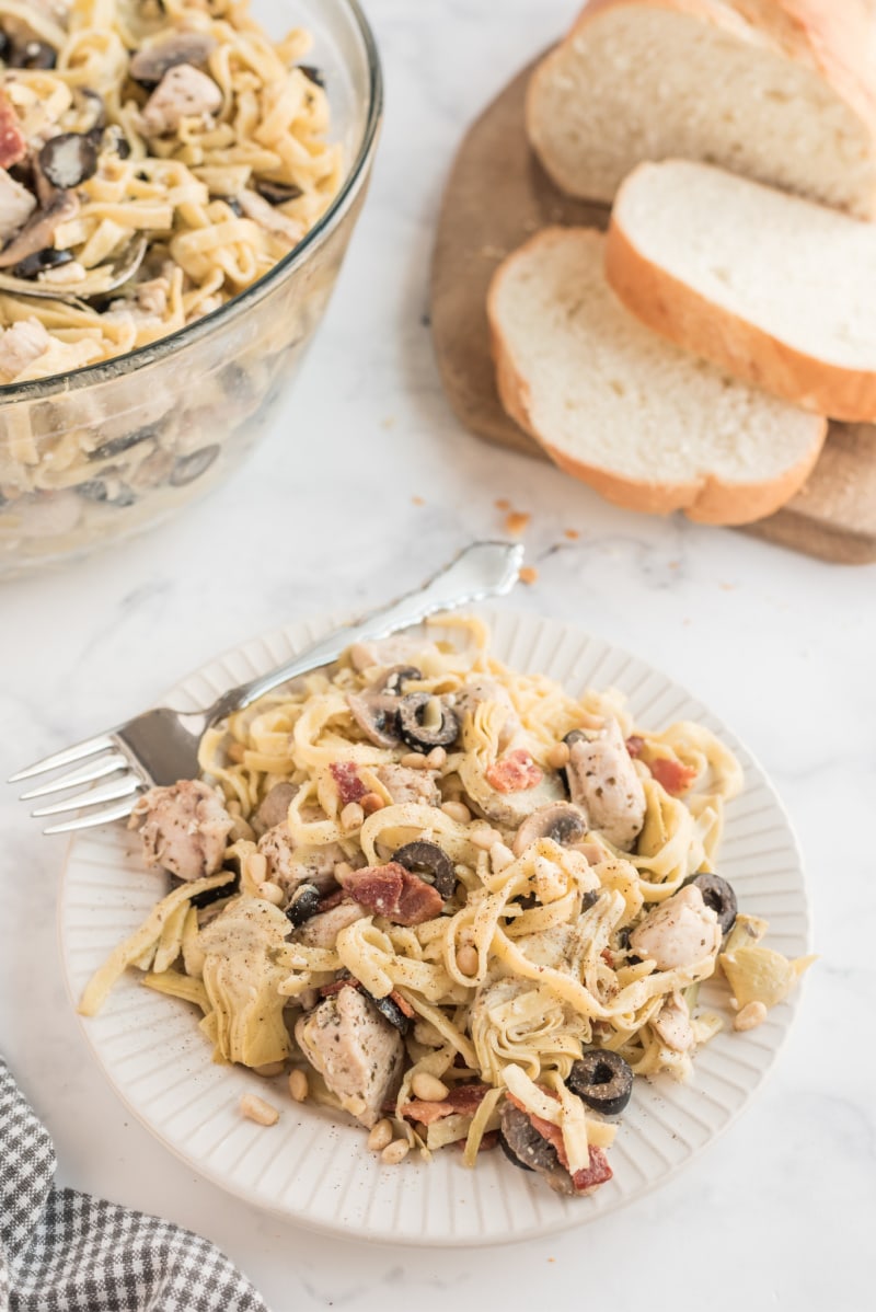 serving of pasta on white plate with fork