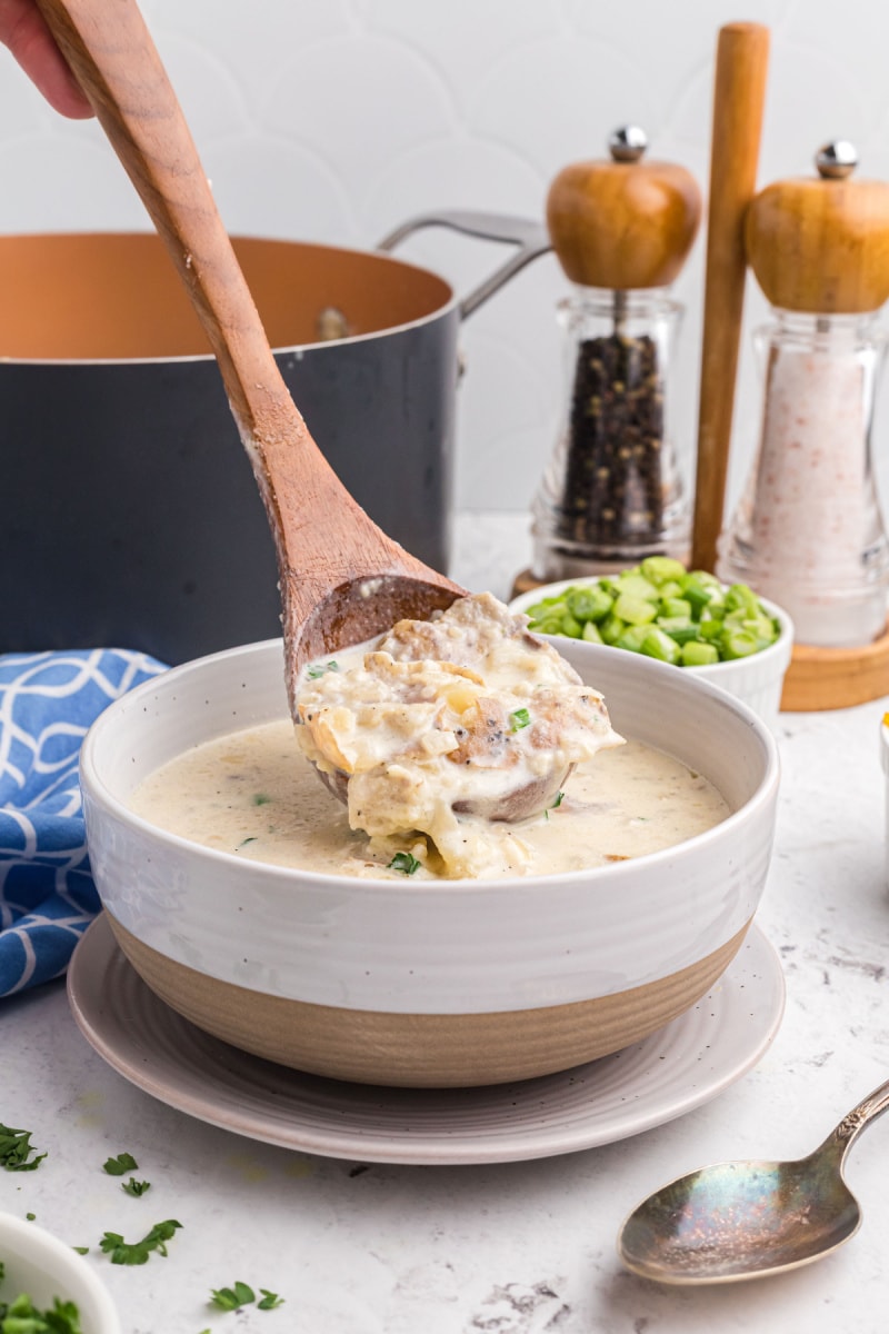 wooden spoon spooning soup into bowl