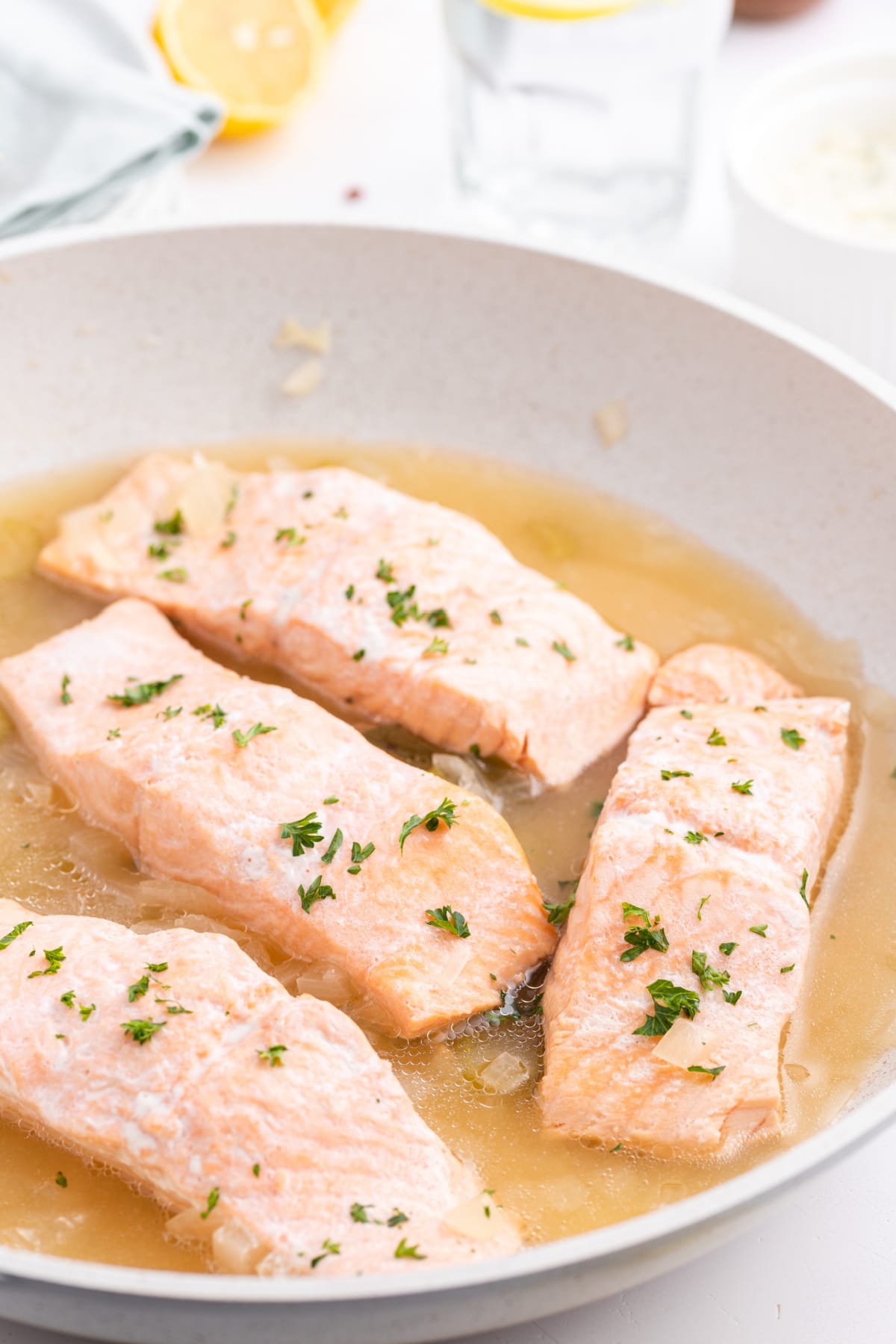 beer poached salmon filets in a skillet