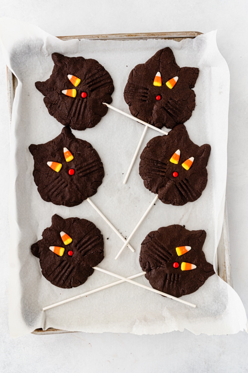 black cat cookies on a baking sheet