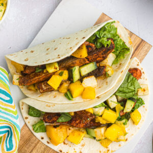 two blackened salmon tacos on plate