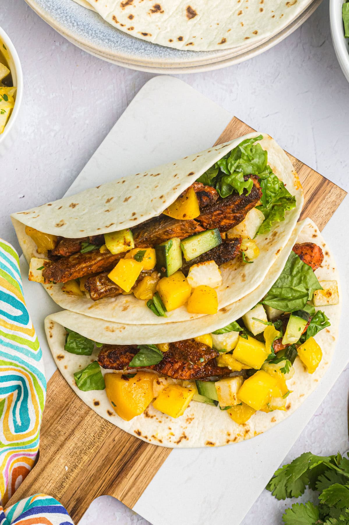 Blacked Salmon Tacos with Mango Salsa recipe from RecipeGirl.com : fish tacos two blackened salmon tacos on plate