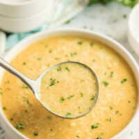 ladle of butternut squash soup above bowl