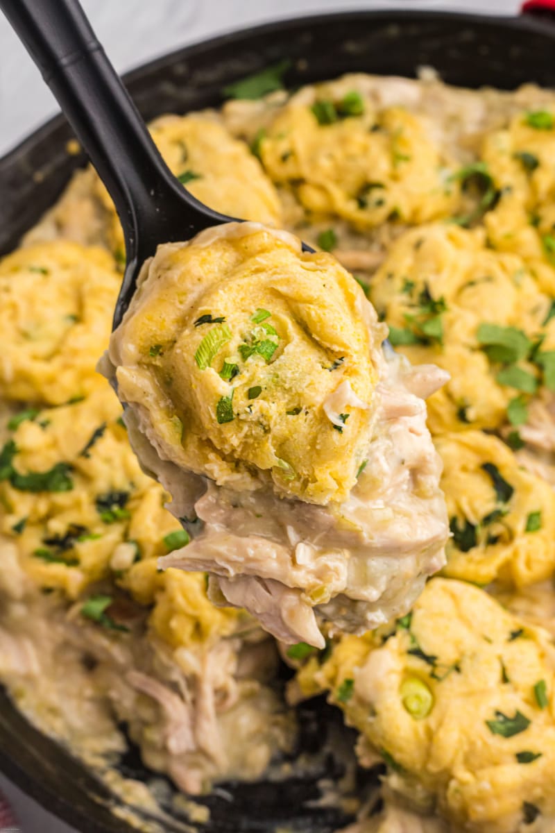 spoonful of chicken salsa verde above skillet