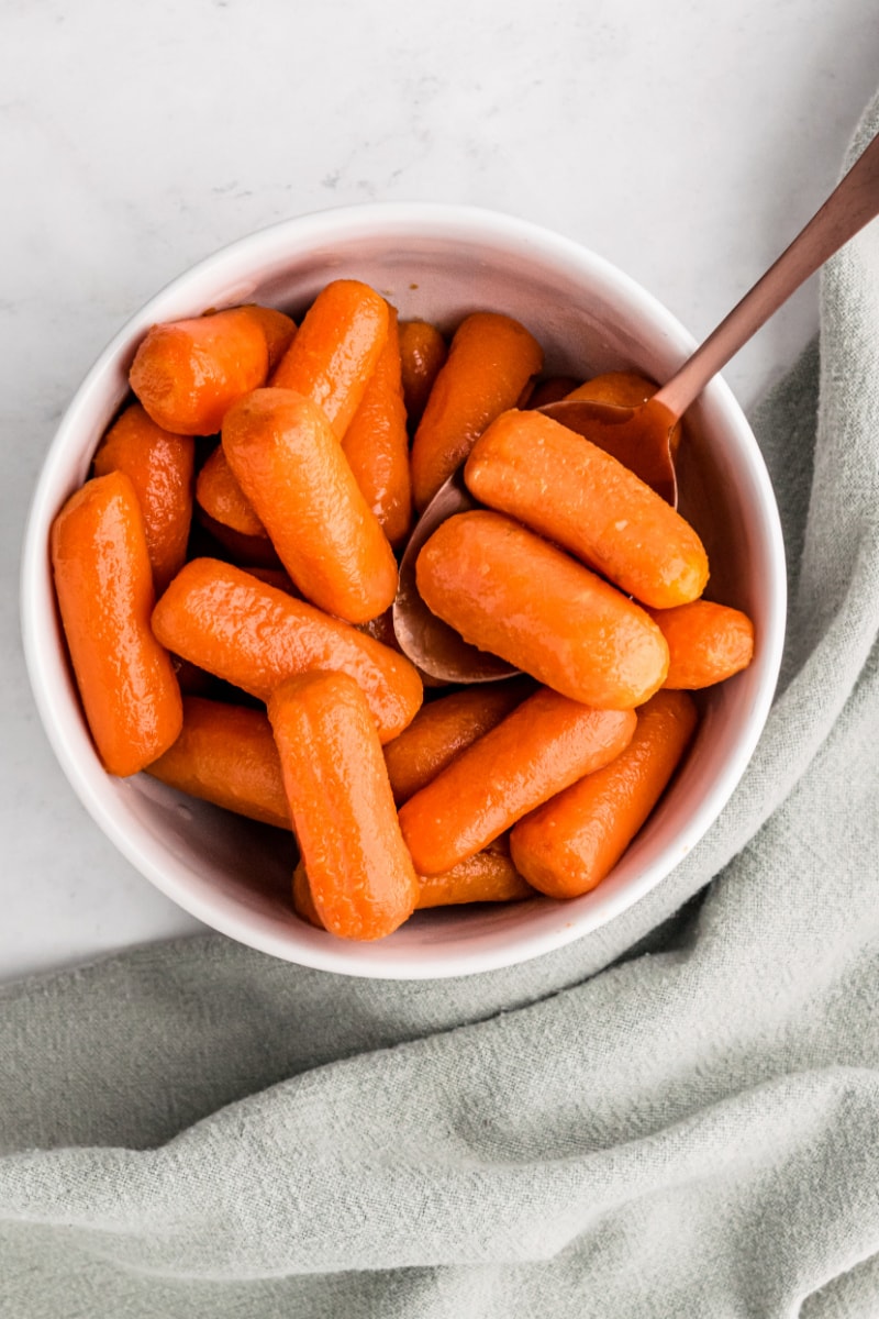 bowl of glazed carrots with a spoon