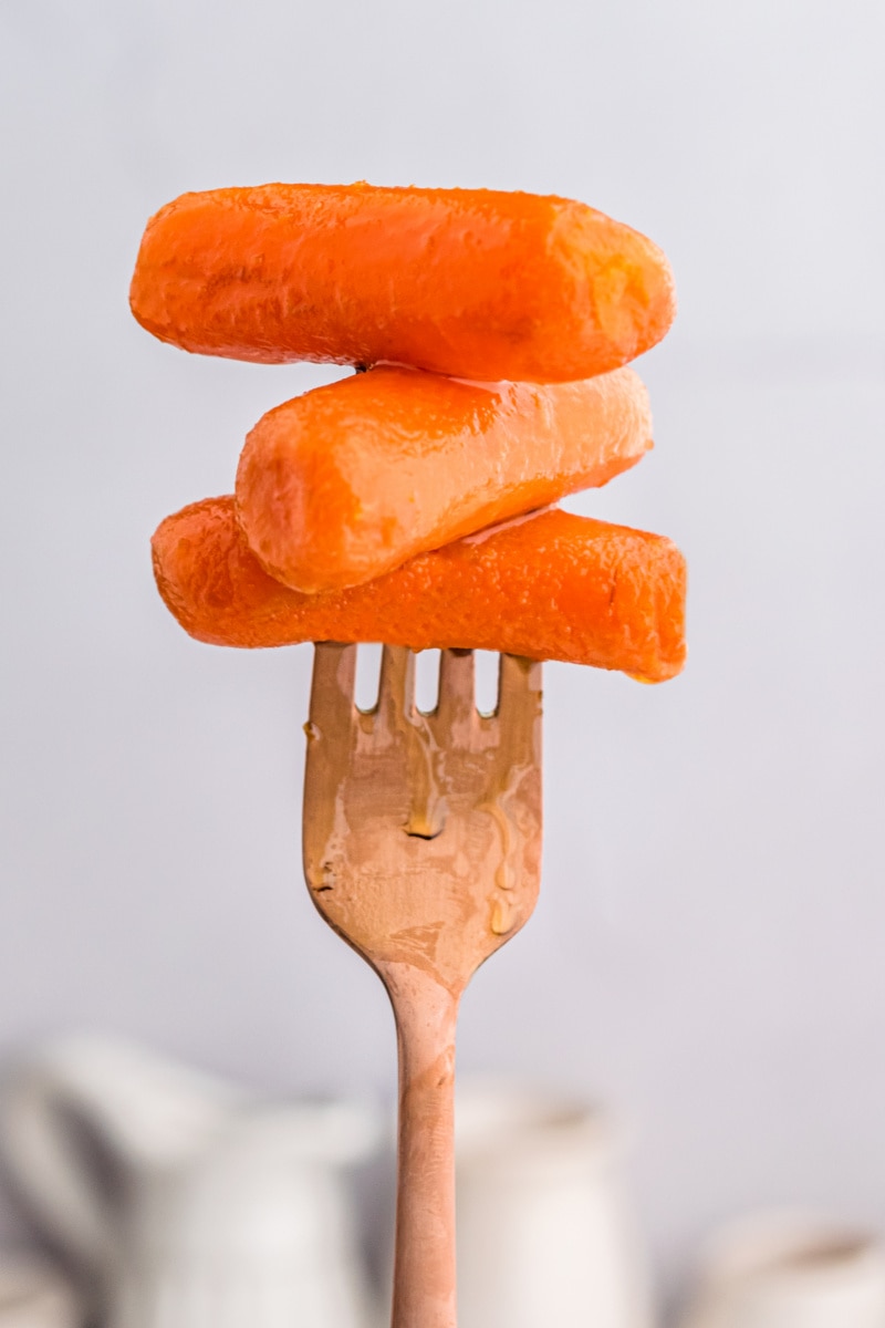 fork full of three glazed carrots