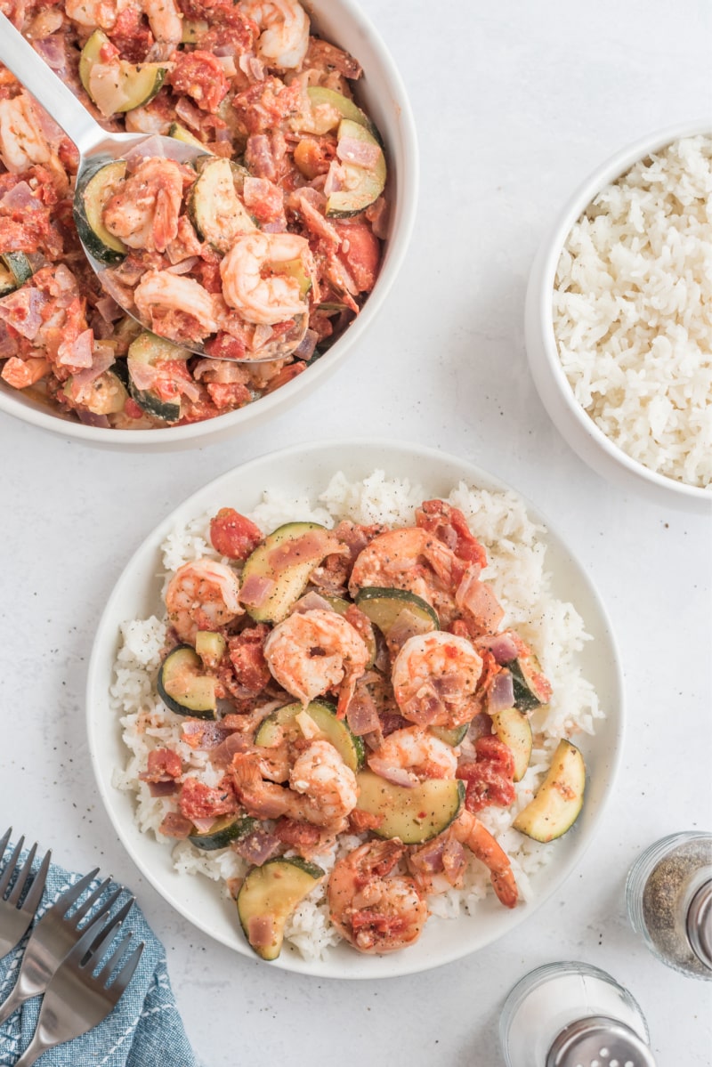 greek shrimp over rice on a white plate