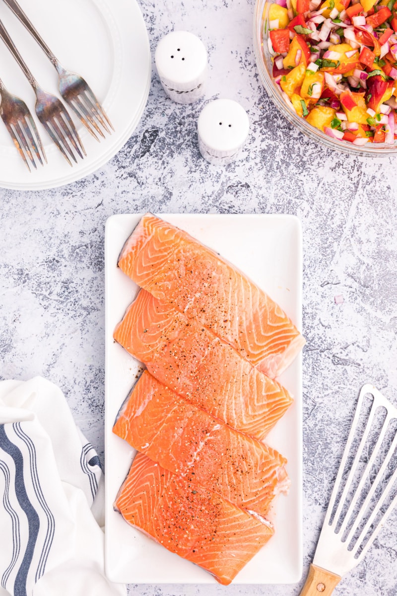 salmon fillets on a platter ready for grill