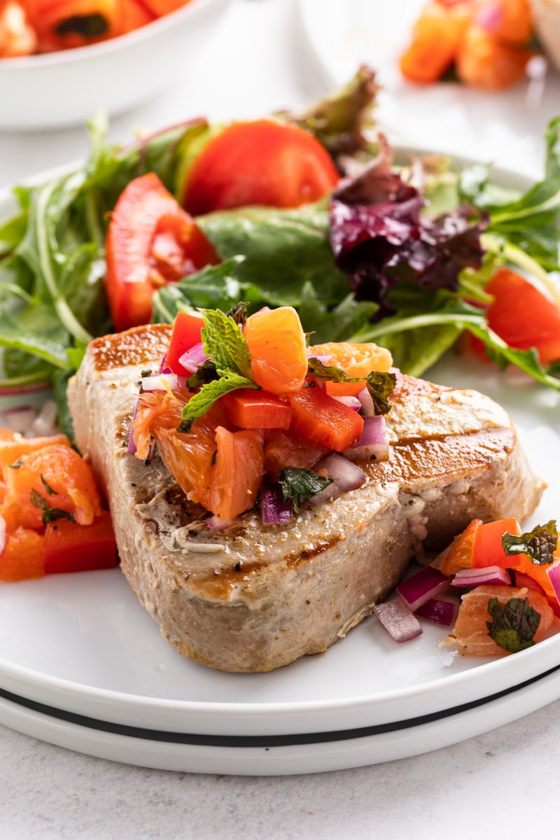grilled tuna with citrus salsa on a plate with salad