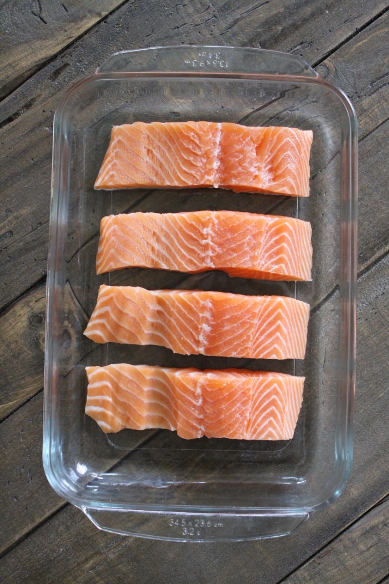 four salmon filets in pan