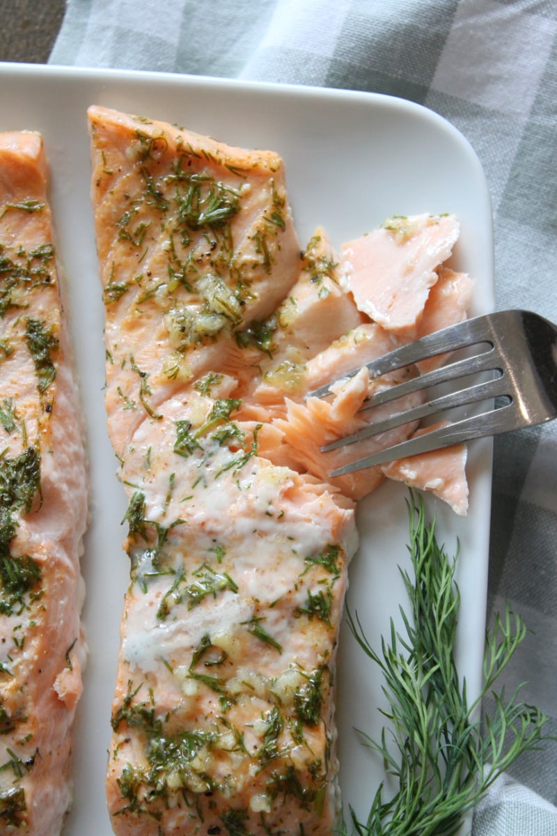 fork pulling cooked salmon