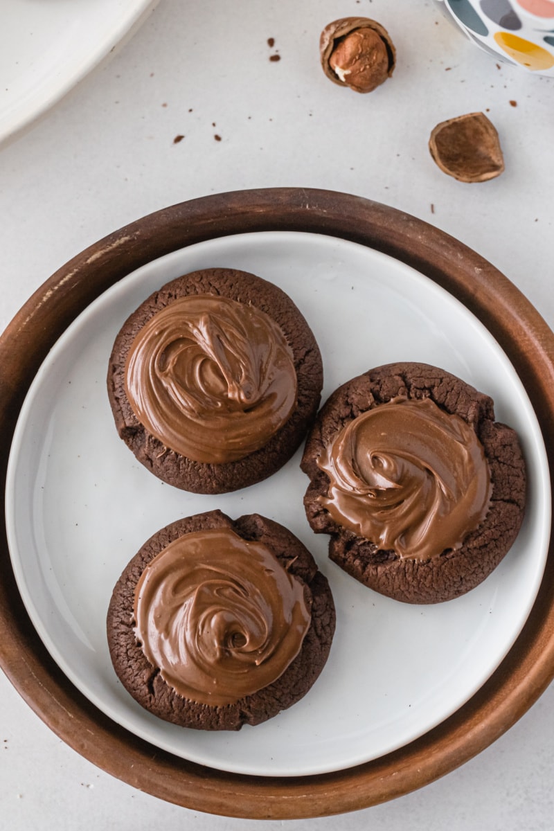 three nutella thumbprint cookies on a plate