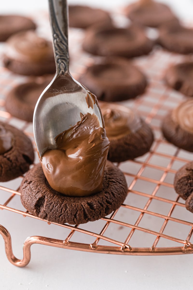 spooning nutella onto chocolate cookie