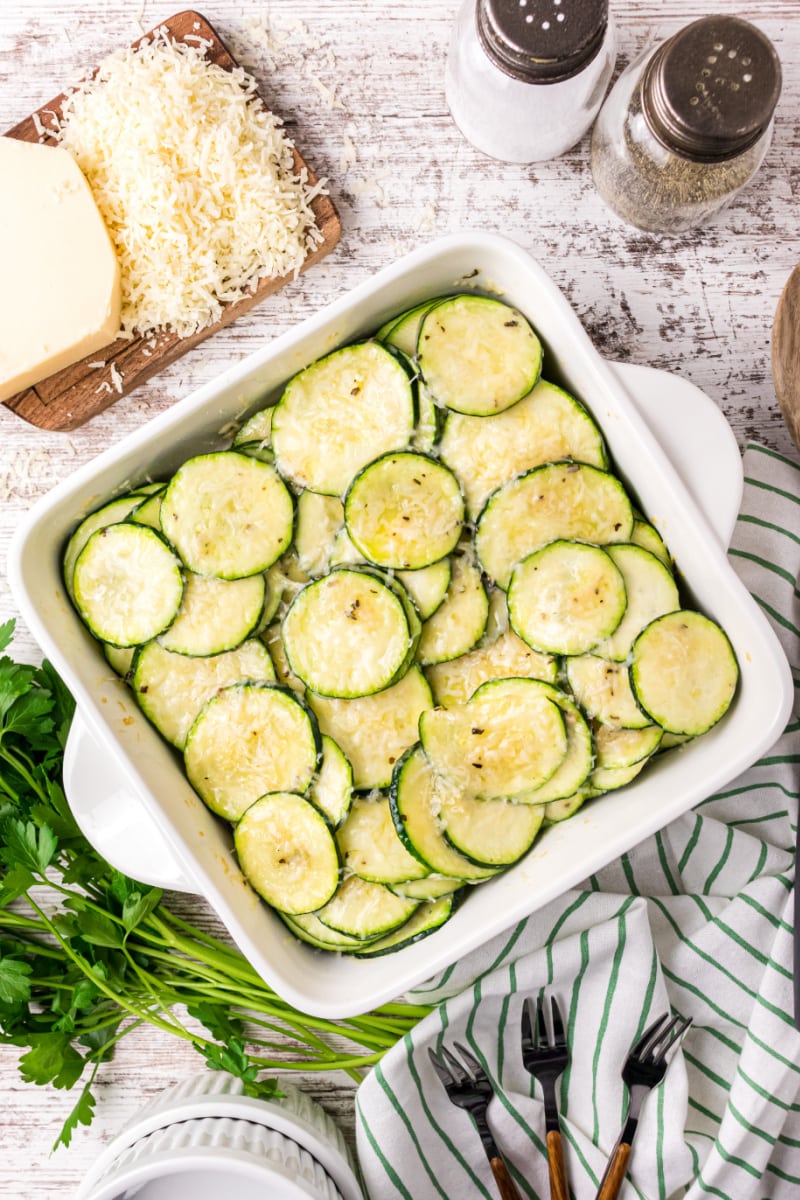square white baking dish with parmesan zucchini slices