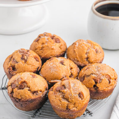 pumpkin cinnamon chip muffins on a baking rack