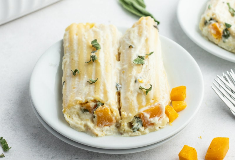 serving of two pumpkin manicotti on white plate