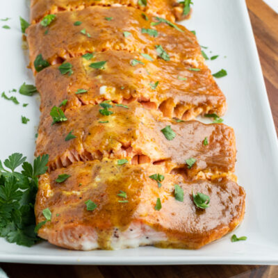 white tray with salmon with mustard and brown sugar glaze