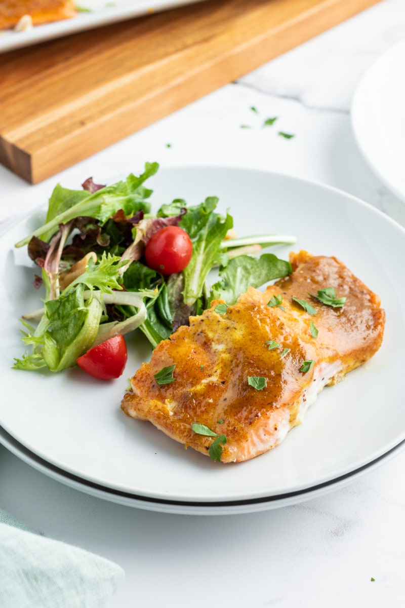 serving of salmon and salad on a white plate