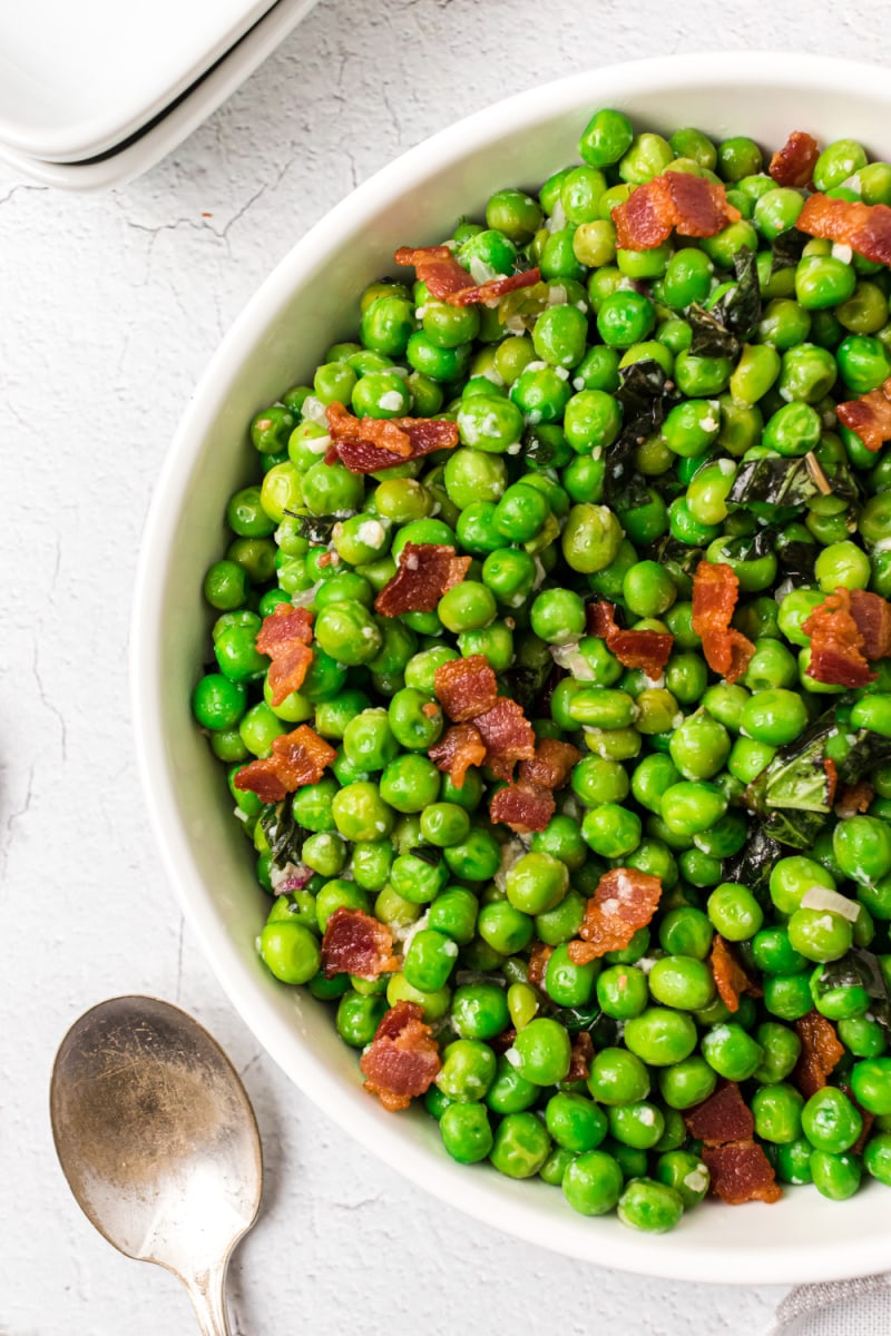 bowl of sauteed peas with basil and bacon