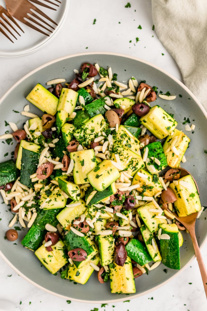 skillet of sauteed zucchini with almonds and olives