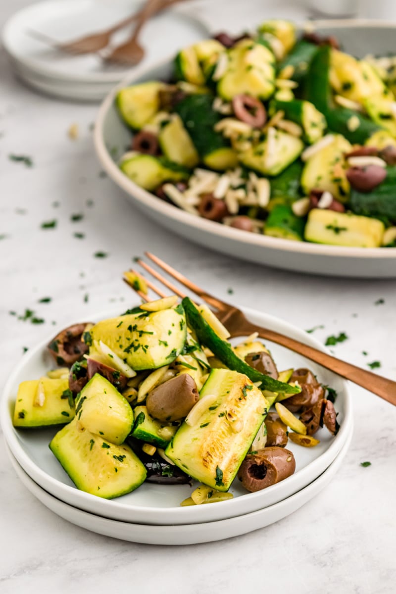 serving of sauteed zucchini with almonds and olives on a plate