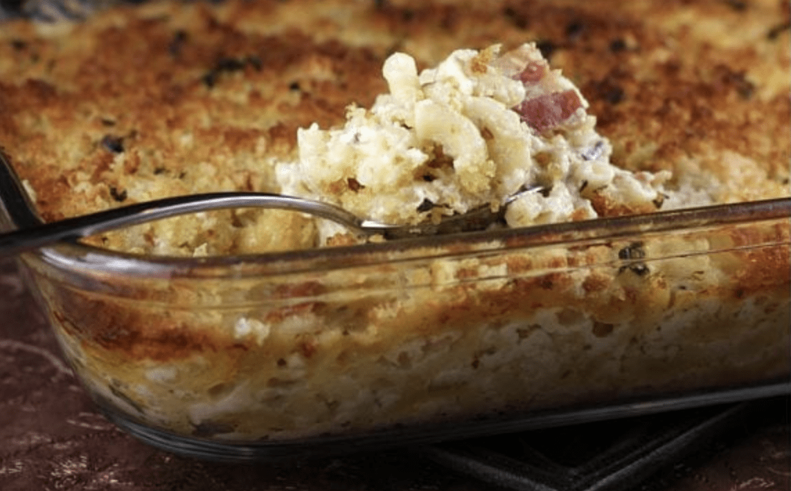 spooning macaroni and cheese out of pan