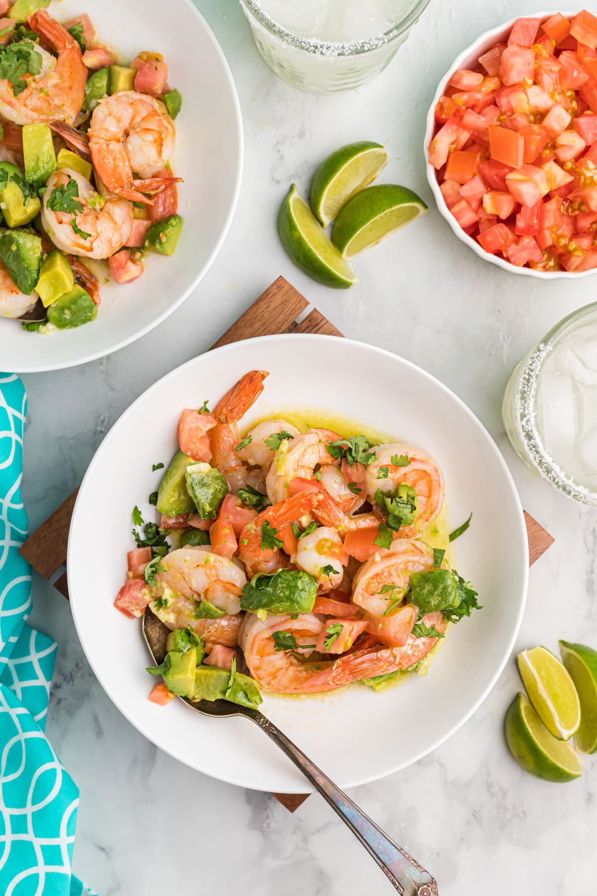 servings of shrimp mezcal on plates with fork