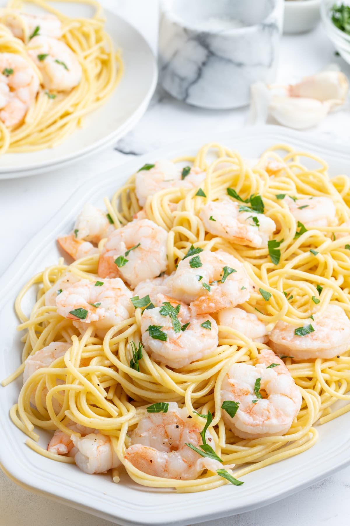 shrimp scampi over pasta on platter
