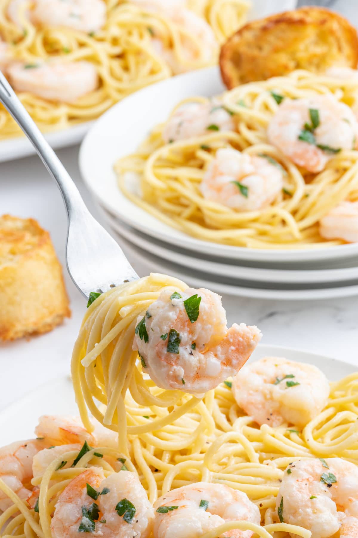 fork full of shrimp scampi with pasta