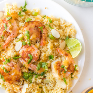 plate of shrimp with couscous and ginger orange sauce